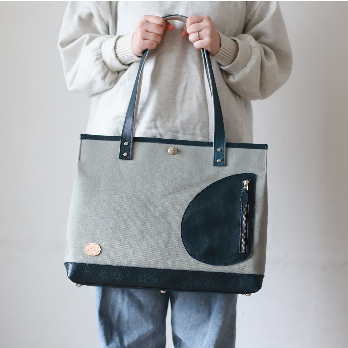 トートバッグ DUOトートver2 ｜ 帆布 牛革 ネイビー×グレー 使用イメージ 女性 正面